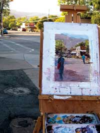 Painters easel and painting on Center Street sidewalks